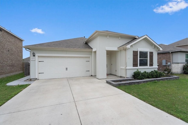 view of front of property with a garage and a front lawn