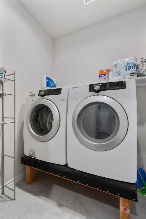 clothes washing area featuring washer and clothes dryer