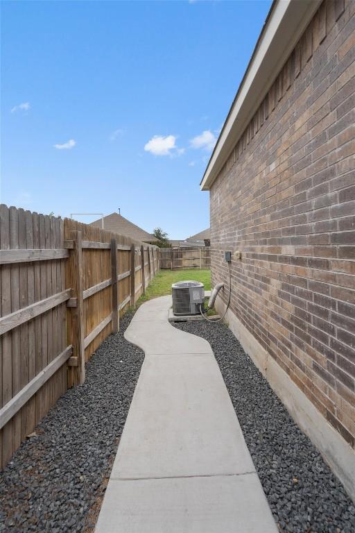 view of yard featuring central AC and a patio area