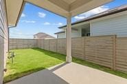 133 Gouda Dr, Bastrop, TX 78602 - fenced backyard with a patio