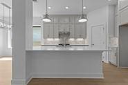 133 Gouda Dr, Bastrop, TX 78602 - kitchen with light countertops and pendant lighting