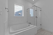 133 Gouda Dr, Bastrop, TX 78602 - bathroom featuring an enclosed shower and a tub