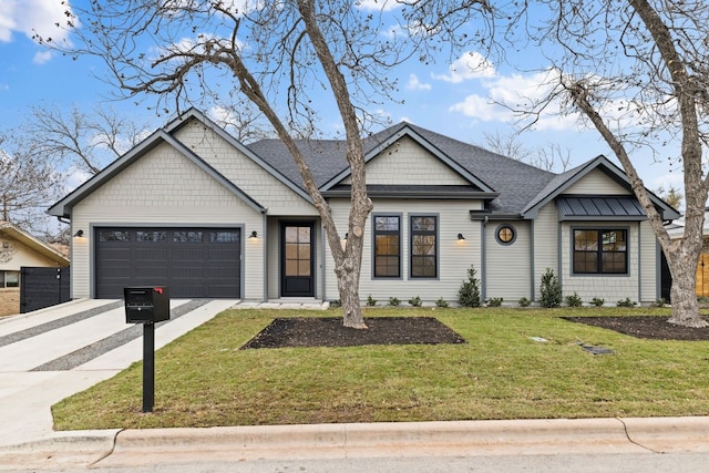 view of front of house with a garage and a front yard