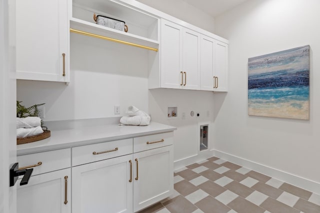 clothes washing area featuring cabinets, hookup for a washing machine, gas dryer hookup, and hookup for an electric dryer