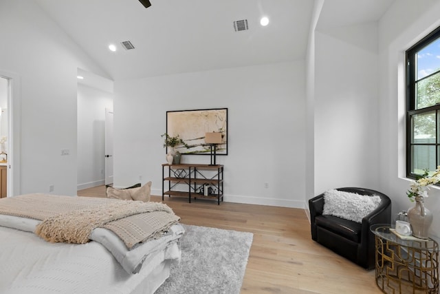 bedroom featuring light wood-type flooring, high vaulted ceiling, and ceiling fan