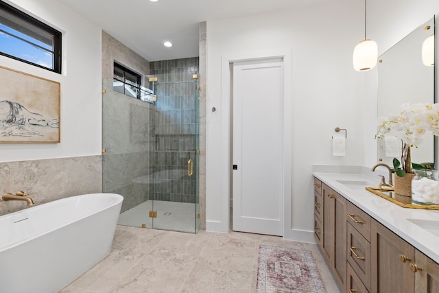 bathroom with vanity, separate shower and tub, and tile walls