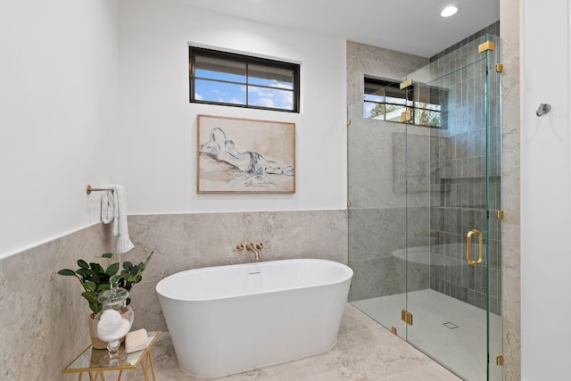 bathroom with plus walk in shower and tile walls