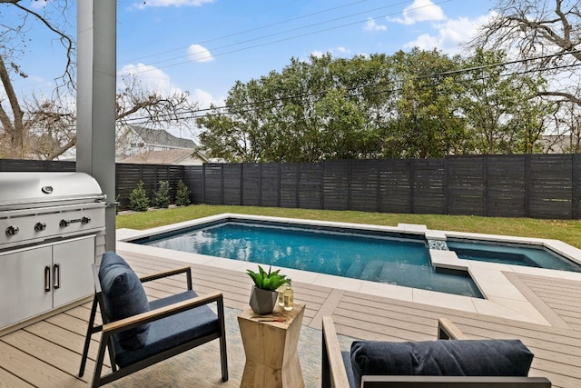 view of swimming pool with area for grilling and a wooden deck