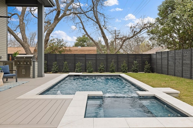 view of pool with a wooden deck, an in ground hot tub, and grilling area