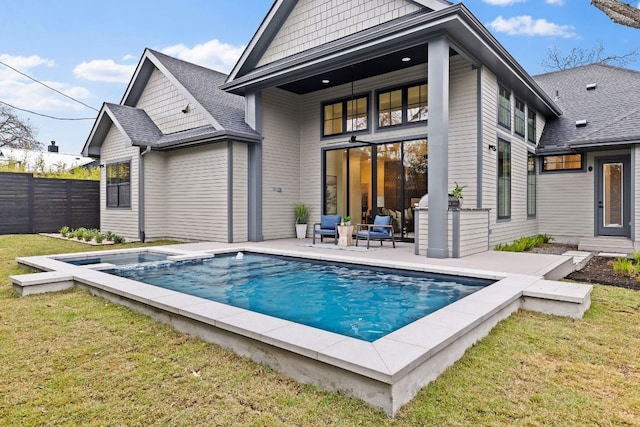 rear view of house with a fenced in pool, a yard, and a patio