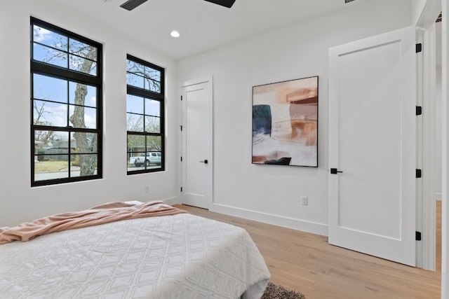 bedroom with ceiling fan and light hardwood / wood-style floors