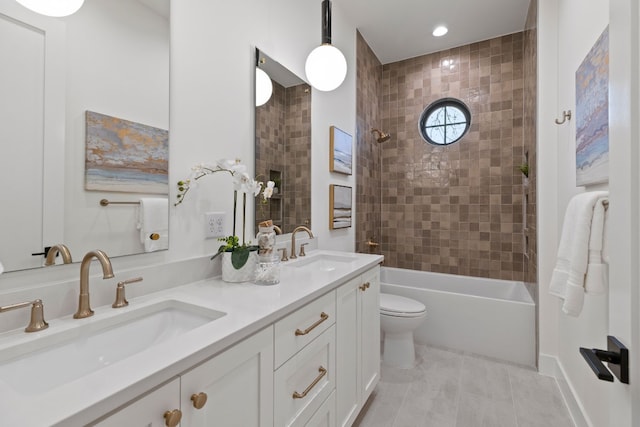 full bathroom with tile patterned floors, vanity, toilet, and tiled shower / bath combo