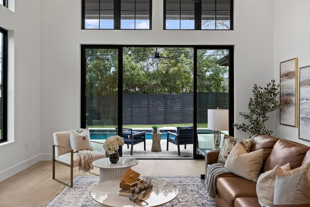 interior space featuring wood-type flooring and a high ceiling