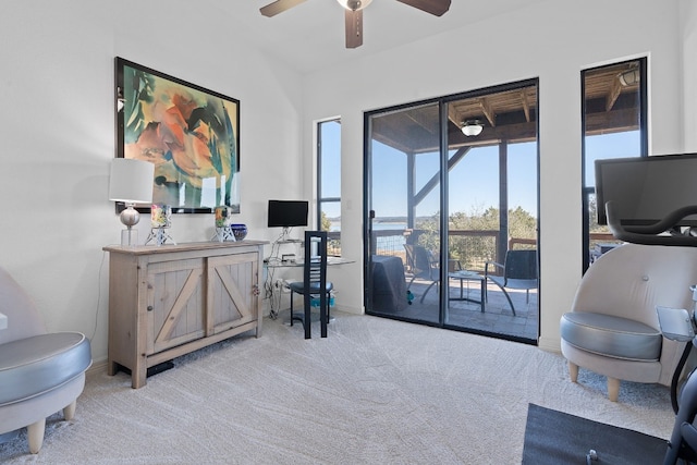 living area with ceiling fan and light colored carpet