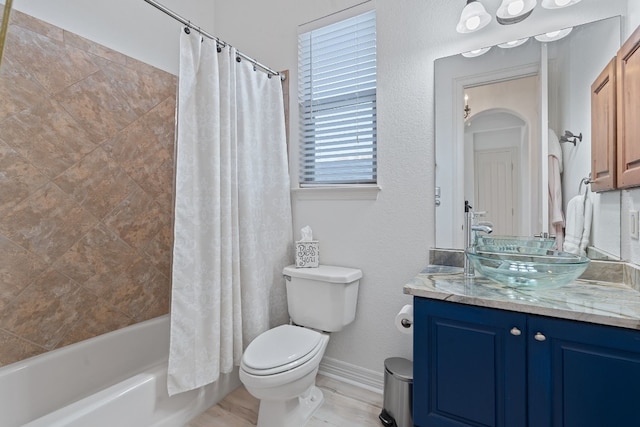 full bathroom with shower / tub combo with curtain, vanity, and toilet