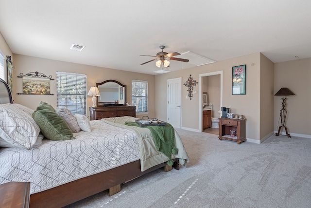 carpeted bedroom featuring ensuite bathroom and ceiling fan