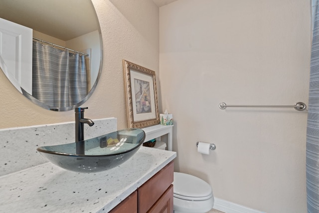 bathroom with vanity and toilet