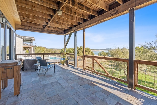 unfurnished sunroom featuring a water view