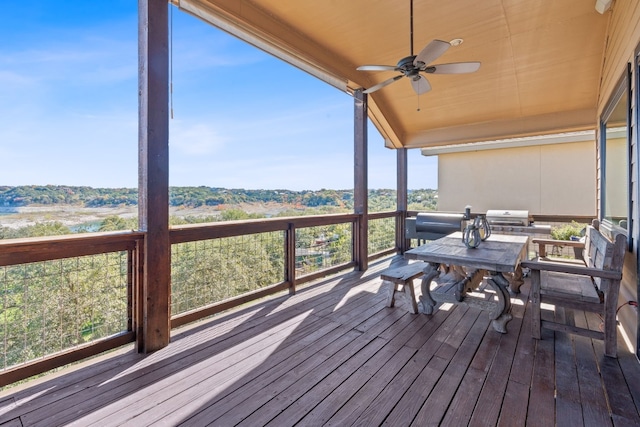 deck with grilling area and ceiling fan