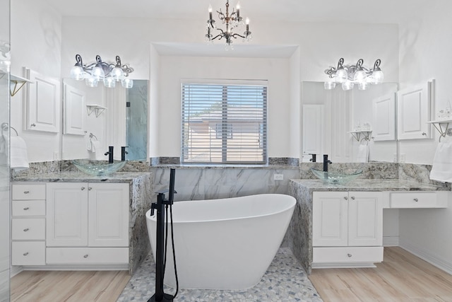 bathroom featuring vanity, wood-type flooring, a tub to relax in, and tile walls