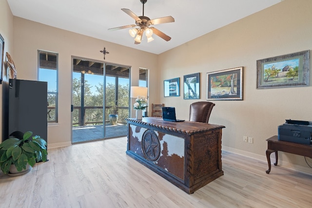 home office with ceiling fan and light hardwood / wood-style floors