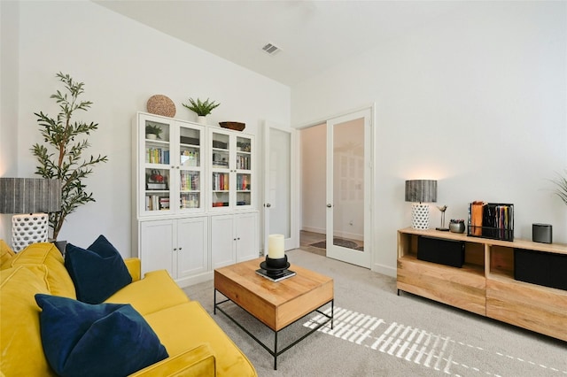 living room with light carpet and french doors