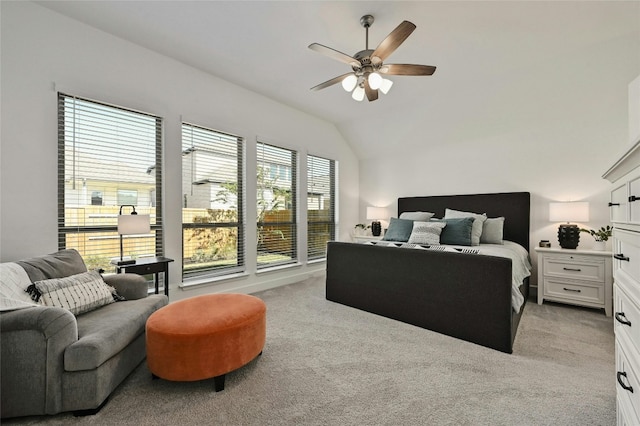 bedroom with multiple windows, ceiling fan, light carpet, and vaulted ceiling