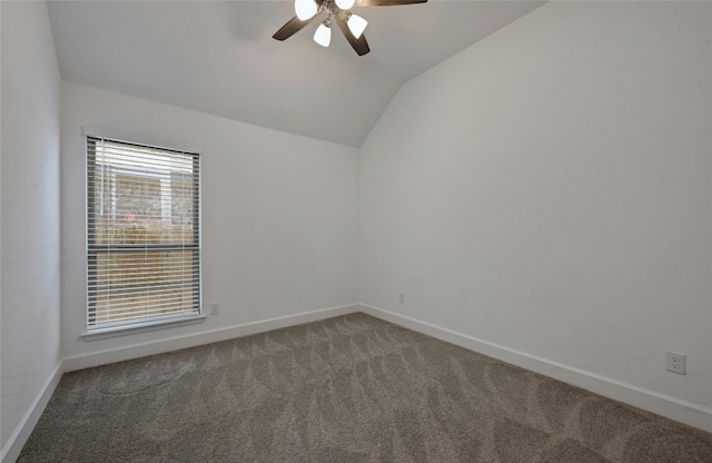 carpeted spare room with vaulted ceiling and ceiling fan