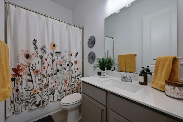 full bathroom featuring vanity, shower / bath combination with curtain, and toilet