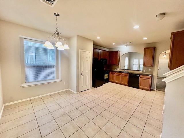 10508 Wylie Dr, Austin, TX 78748 - kitchen with black appliances, arched walkways, a chandelier, light tile patterned floors, and decorative light fixtures