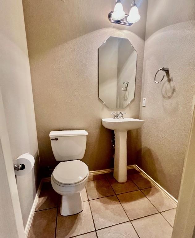 bathroom with tile patterned floors and toilet