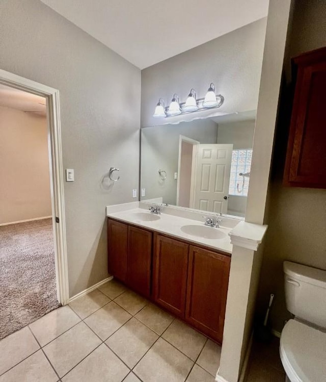 bathroom with tile patterned flooring, vanity, and toilet