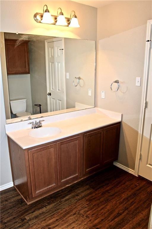 bathroom featuring vanity, toilet, and wood-type flooring