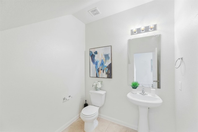 bathroom featuring tile patterned floors, toilet, and vaulted ceiling