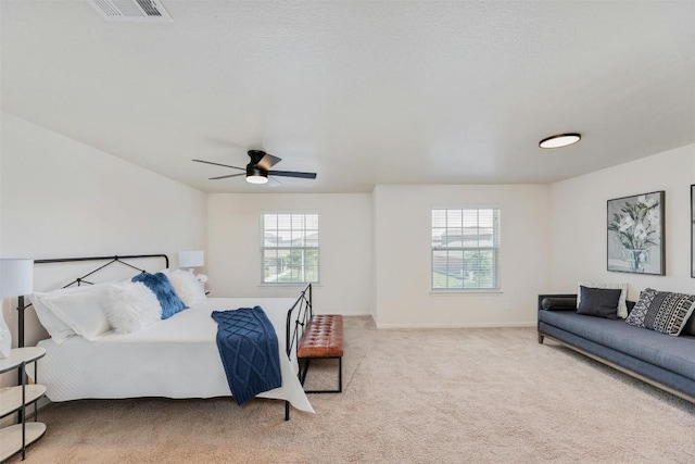 bedroom with multiple windows, carpet flooring, and ceiling fan