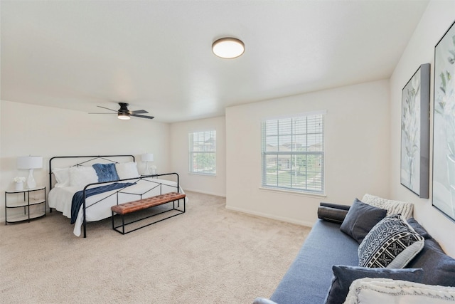 bedroom with ceiling fan and light carpet