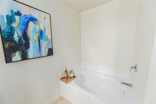 bathroom with a tub to relax in and tile patterned flooring