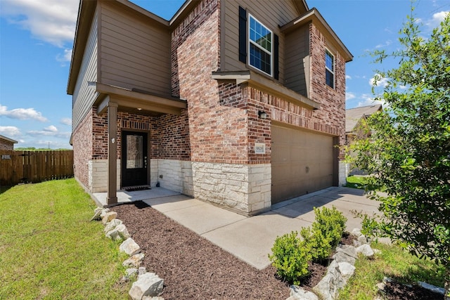 view of front of property with a garage and a front yard