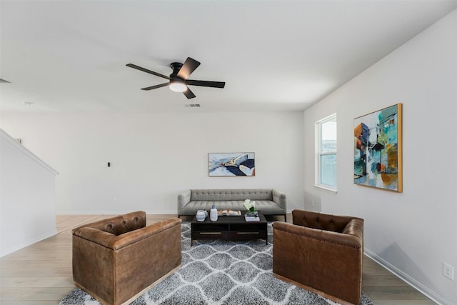 living room featuring hardwood / wood-style flooring and ceiling fan