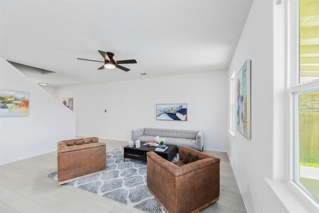 living room with ceiling fan and light hardwood / wood-style flooring