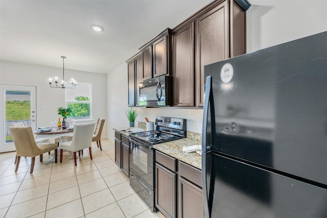 kitchen featuring dark brown cabinetry, light stone countertops, a chandelier, pendant lighting, and black appliances