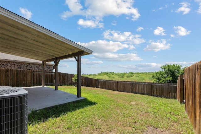 view of yard featuring a patio area and central air condition unit