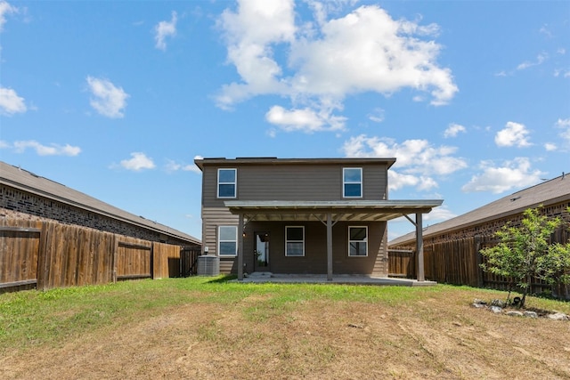 back of house with a lawn, cooling unit, and a patio area