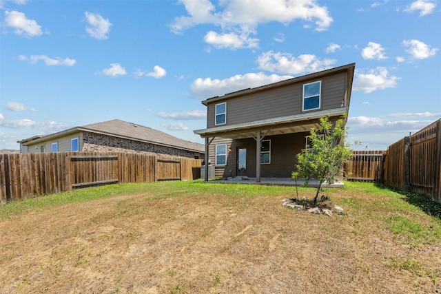 rear view of house with a patio area and a yard