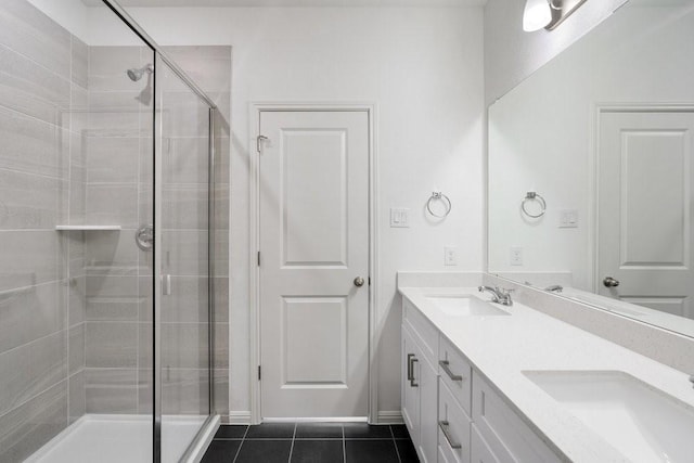 bathroom featuring vanity, a shower with shower door, and tile patterned flooring