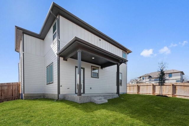 rear view of house with a yard