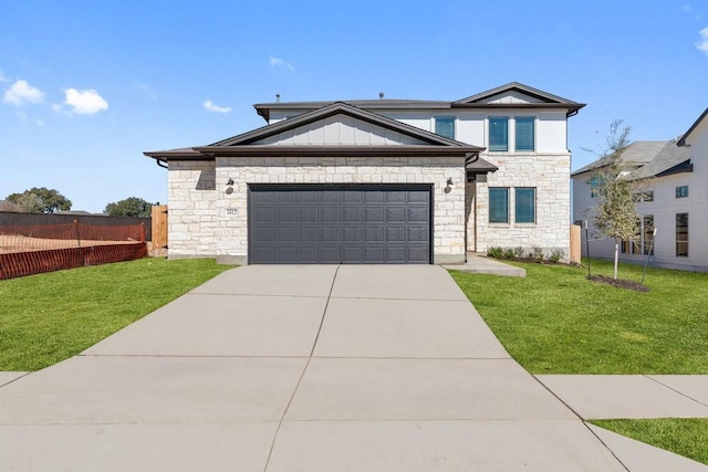 view of front of house with board and batten siding, fence, a front yard, a garage, and driveway