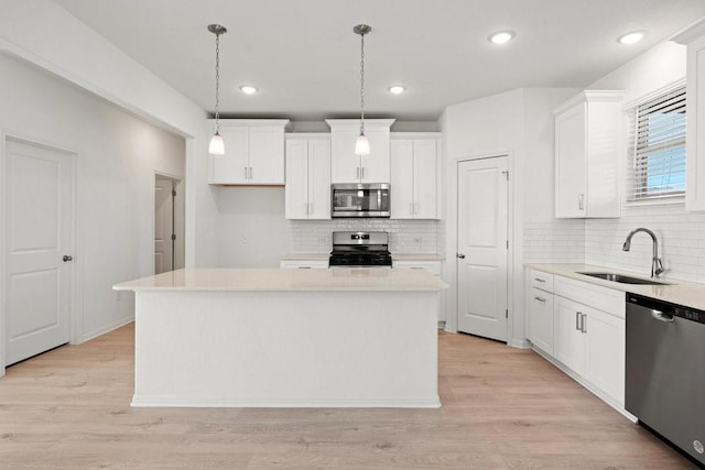 kitchen featuring a kitchen island, white cabinets, and appliances with stainless steel finishes