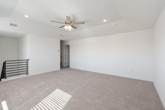 carpeted spare room featuring ceiling fan and lofted ceiling