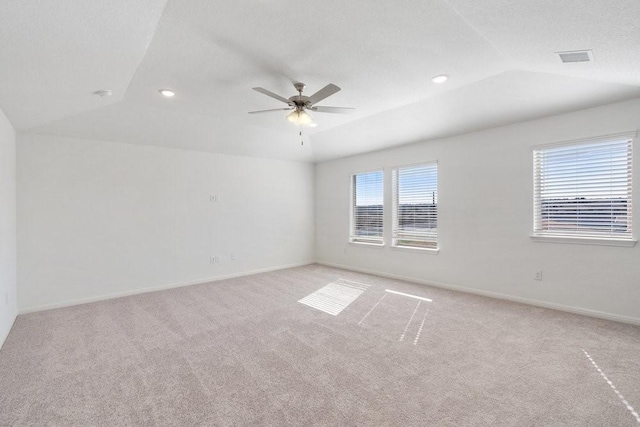 unfurnished room with vaulted ceiling, light carpet, and ceiling fan